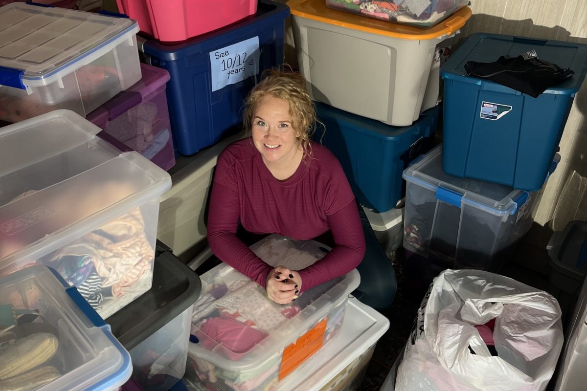 Lauren Flaherty surrounded by donations in her home. Phot credit: Addie Bruni.